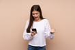 © luismolinero - Young girl over isolated background surprised and sending a message