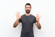 © luismolinero - Young handsome man over isolated white background counting nine with fingers