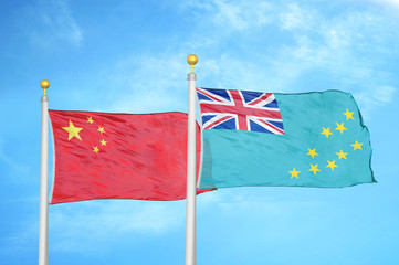 china and tuvalu two flags on flagpoles and blue cloudy sky