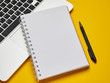 © Владислав Винокуров - Workplace - laptop, notebook and pen for remote work on a yellow background table. Freelance desktop for home or office. Background with copy space.