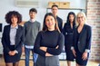 © Krakenimages.com - Group of business workers smiling happy and confident. Posing together with smile on face looking at the camera, young beautiful woman with crossed arms at the office