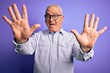 © Krakenimages.com - Middle age handsome hoary man wearing striped shirt and glasses over purple background showing and pointing up with fingers number ten while smiling confident and happy.