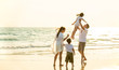 © CandyRetriever  - Happy Young Asian happy family parents with child walking and having fun together on the beach at sunset in summertime. Father, mother and kids relax and enjoy summer lifestyle travel holiday vacation