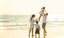 Happy Young Asian Happy Family Parents With Child Walking And Having Fun Together On The Beach At Sunset In Summertime. Father, Mother And Kids Relax And Enjoy Summer Lifestyle Travel Holiday Vacation