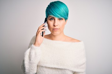 Sticker - Young woman with blue fashion hair having a conversation talking on smartphone with a confident expression on smart face thinking serious