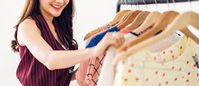 Beautiful Young Asia Woman Shopping And Choosing Clothes In A Store.fashion Shopping Concept