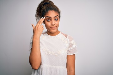 Sticker - Young beautiful african american girl wearing casual t-shirt standing over white background Shooting and killing oneself pointing hand and fingers to head like gun, suicide gesture.