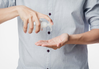 Wall Mural - Young man using hand sanitizer or alcohol gel for washing hands, Corana virus or Covid-19 prevention, Hygiene concept.