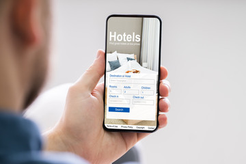 Person Booking Hotels Using Cell Phone
