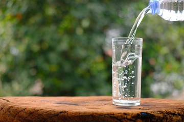 Poster - Glass of water on wood table background