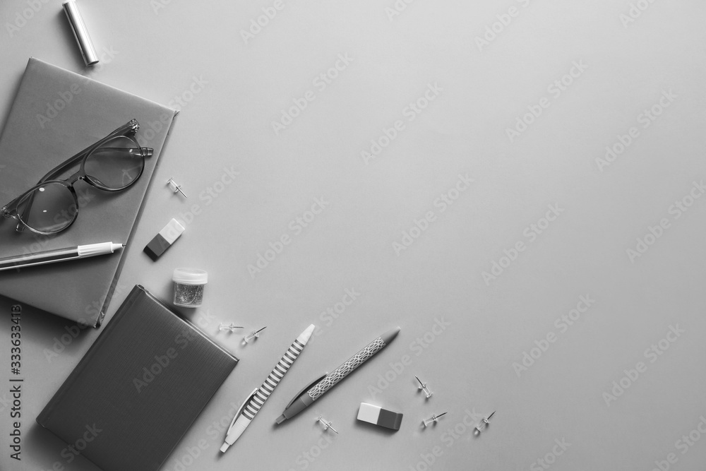 Set of school supplies with eyeglasses on grey background
