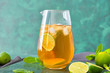 © Pixel-Shot - Jug of tasty cold tea on color background