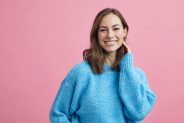 Wall Mural - Portrait for beautiful smiling woman on a pink background, colorful portrait