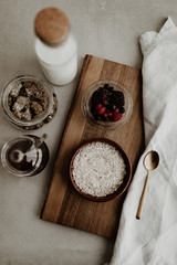 Healthy breakfast ingredients for a balanced diet with fresh fruit, rolled oat, honey and vegan almond milk