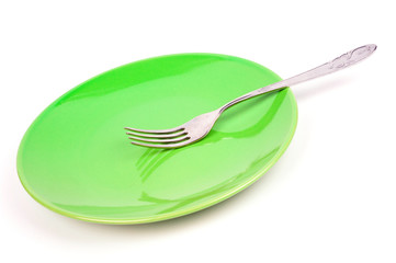 Green plate with fork on white