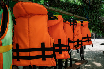 Canvas Print - Close-up group of Life jacket or life vest hanging under the shelter at Pangkor Island, Malaysia