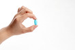 © Othoniel - Blue vitamine in thumbs hand. medicines and vitamins
