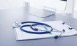 Medical equipment: blue stethoscope and tablet on white background. Medical equipment