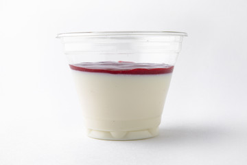 Wall Mural - Dessert delicious pudding, panacota or jelly made from vanilla, jam and chocolate package in a plastic cup for take away or food delivery isolated on a white background.