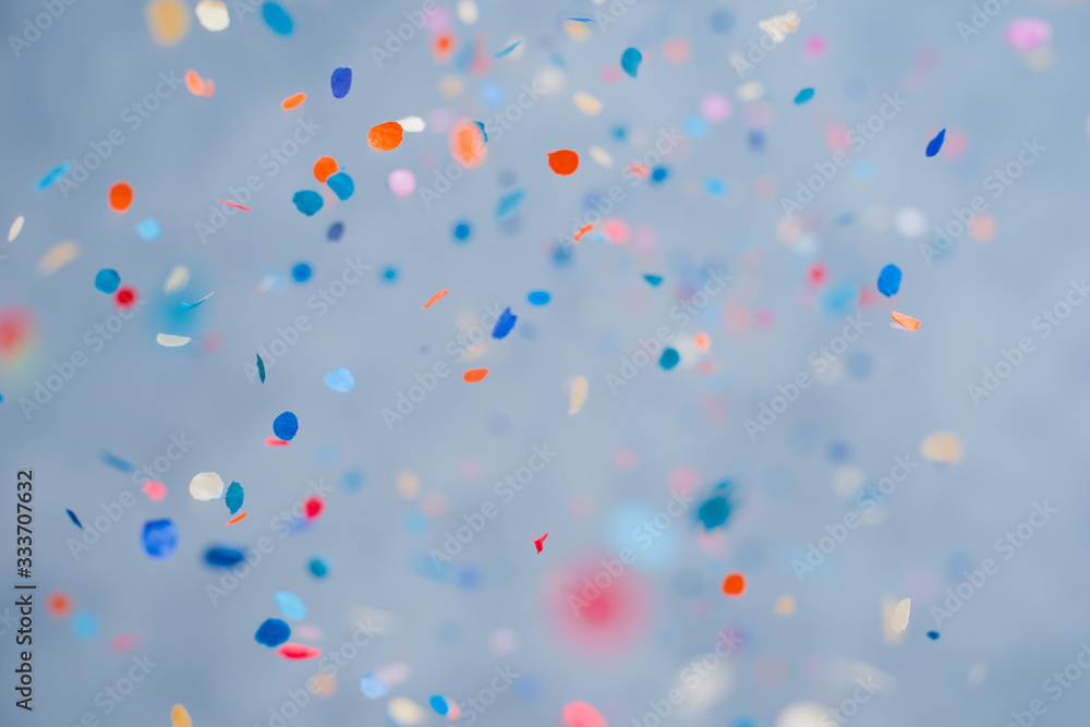 Colorful confetti falling on a holiday on a blue background Stock Photo ...