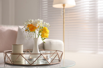 Beautiful bouquet with spring freesia flowers in light room, space for text