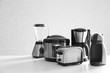 © New Africa - Set of modern home appliances on white table