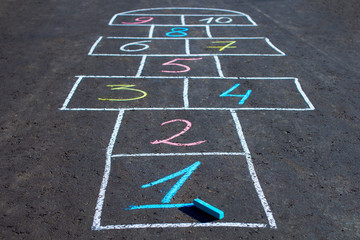 Hopscotch game drawn with chalk on the asphalt