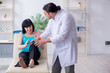 © Elnur - Young male doctor examining old female patient