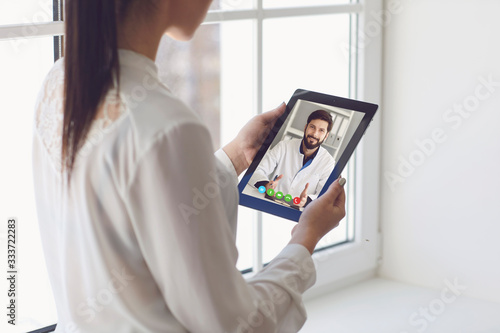 Doctor online. Online medical consultation. Doctor and patient remote consultation on a tablet.