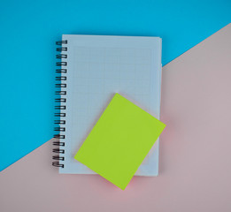 Sticker - Some light green sticky notes on top of a white paper diary before a paper background