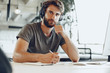 © fotofabrika - Bearded man freelance worker making notes in his notepad. Planning concept