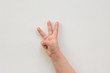 © Tatiana Foxy - Top view of child hand showing three fingers as number three on the white background