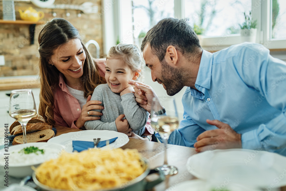 Cheerful family having fun during lunch at dining table. - obrazy, fototapety, plakaty 