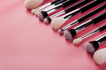 Make up brush lie on a pink background