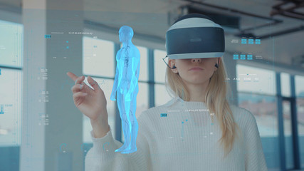 Augmented Reality. Close-up of a Female Doctor Looking: Medical Charts, 3D Hologram (DNA hologram, Pulmonary System, Muscular System, COVID-19) Wearing VR Glasses and Headsets. Future Medicine. VR