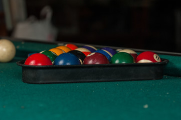 Billiards balls and cue on billiards table. Billiard sport concept