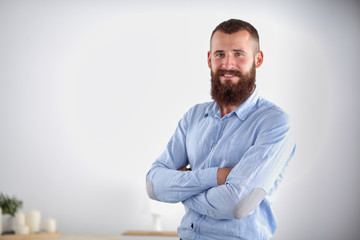 Successful young business man standing in office