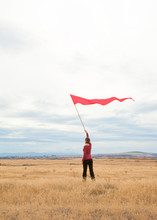 People Woman Alone Outdoors In Field Waving Signal Flag Banner. Communication, Isolation, Social Distancing  Concept.