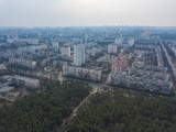 Fototapeta Paryż - The outskirts of Kiev, near coniferous forest. Aerial drone view.