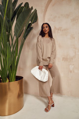 Wall Mural - Beautiful sexy brunette woman face cosmetic makeup tanned skin wear fashion clothes style collection beige knitted suit sandals accessory  bag interior sand safari journey summer wall flowerpot palm.