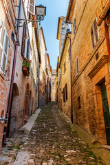 Wall Mural - View of a beautiful narrow steep street in Fermo, Province of Fermo, Marche Region, Italy