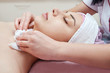 © evafesenuk - Beautician doctor cleans the skin of a young woman