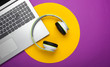 © splitov27 - Laptop with headphones on purple background with yellow circle. DJ, gaming, entertainment or leisure concept. Top view. Flat lay