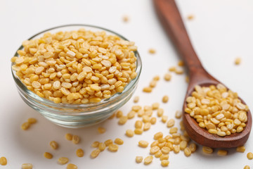 yellow moong mung dal lentil pulse bean in glass bowl on white background