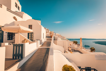 White architecture over street and sea view. Tranquil summer travel and vacation. Beautiful sunset on Santorini island, Greece.