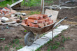 Close up picture of construction site. Bricks in a wheelbarrow