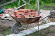 Close up picture of construction site. Bricks in a wheelbarrow