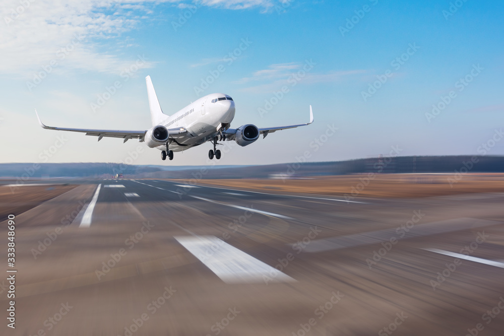 Runway at the airport and the plane flies and landing. - obrazy, fototapety, plakaty 