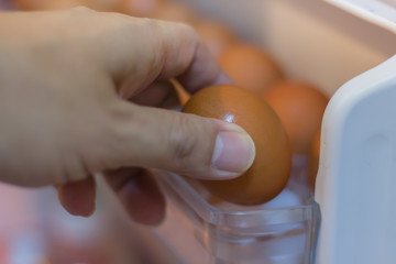 Pick up the chicken eggs from the refrigerator.