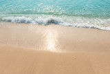 Fototapeta Morze - Blue ocean waves Sunlight Reflection Sand Beach background